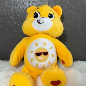 preowned, yellow Care Bear, good condition